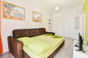 a bed in a room with a couch and a tv at Cascais Holiday House - Checkinhome in Cascais