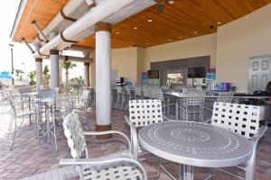 a patio with a table and chairs and a kitchen at 545 OC - CHAMPIONS GATE in Kissimmee