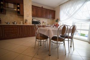 a kitchen with a table and chairs in a kitchen at Villa BALTICA in Rowy