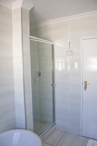 a shower with a glass door in a bathroom at Princess Holiday Home in Cape Town +45 photos