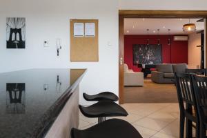 a view of a living room and dining room at Alexander Apartments Airport in Spáta