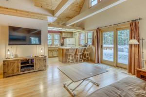 a large living room with a table and a kitchen at Snowpeak Chalet in Tahoe Donner in Truckee