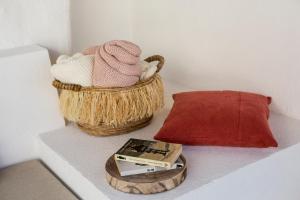 a shelf with a basket and a book on it at Sea'Ya Thoughtful Stays - Villas in Cascais