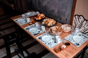 a table with plates and bowls of food on it at Che Juan Hostel BA in Buenos Aires