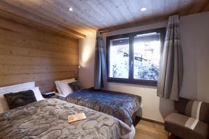 Tempat tidur dalam kamar di Chalet Le Challenge - Les 2 Alpes