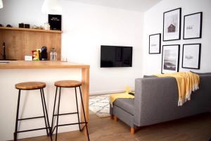 a living room with a couch and a table at VOYA NORDIC Apartment-a luxury oasis in the old town in Braşov