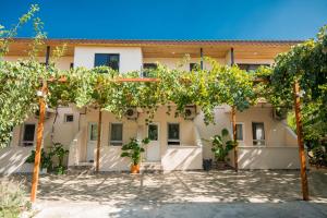 a courtyard with trees in front of a building at Beyoglu Pansiyon in Patara