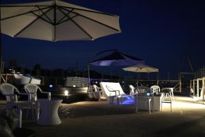 a group of chairs and umbrellas on a patio at night at Mykonos Resort Miura / Vacation STAY 62208 in Yokosuka