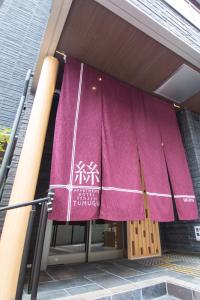 a purple flag on the front of a building at Apartment Hotel Tenjin TUMUGU / Vacation STAY 62166 in Susakiuramachi