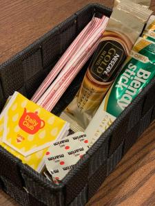 a basket filled with food and other items on a table at Apartment Hotel Tenjin TUMUGU / Vacation STAY 62178 in Susakiuramachi