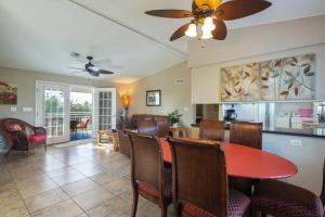 a dining room and living room with a red table and chairs at Sombrero Sands in Marathon