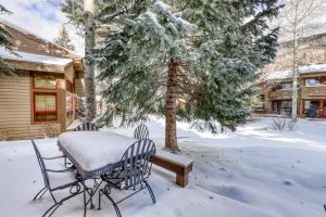 a table and chairs in the snow in front of a house at Meadow Drive 18 in West Vail