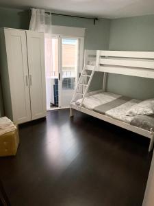 a bedroom with two bunk beds and a window at Apto Arima Centro Histórico in Zaragoza