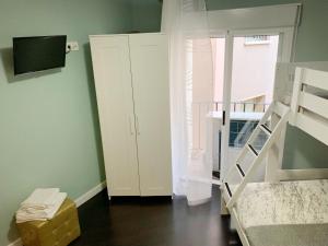 a bedroom with a white cabinet and a staircase at Apto Arima Centro Histórico in Zaragoza
