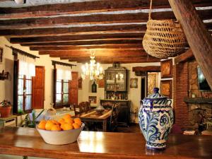 a kitchen with a table with a vase and oranges on it at Molino Rodete in Jimera de Líbar