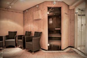 a barbershop with chairs and a wall of wood at Chalet Madlein in Ischgl