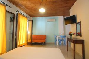 a bedroom with a bed and a table and a chair at Vicky Apartments in Nikiana
