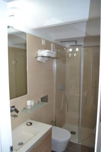 a bathroom with a shower and a toilet and a sink at DUPLEX ALAMEDA DE HERCULES in Seville