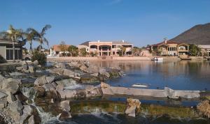 a large pool of water in a yard with houses at Glendale Arizona Lakeside Property in Glendale