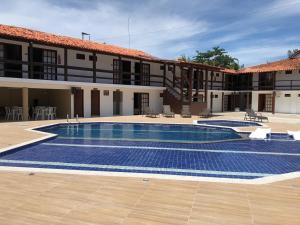 a large swimming pool in front of a building at Hotel Monte Pascoal Smart in Porto Seguro