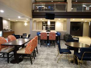 プロボにあるBest Western Plus Provo University Innのテーブルと椅子のあるレストラン、キッチンが備わります。