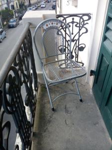 una silla de metal en un balcón con mesa en Gelsomino 74, en Florencia