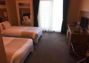 A bed or beds in a room at City Hotel Plovdiv
