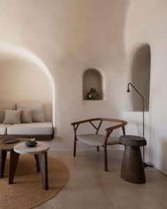 a living room with a couch and a table at Vora in Imerovigli