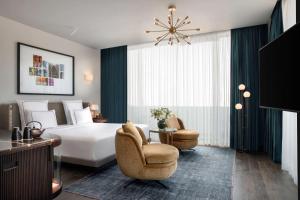 - une chambre avec un grand lit blanc et deux chaises dans l'établissement Glens Palas Istanbul, à Istanbul