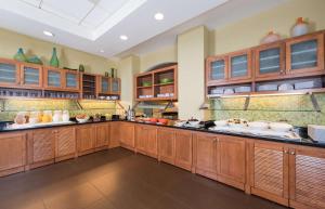 a large kitchen with wooden cabinets and counters at Hyatt Place Charleston Airport / Convention Center in Charleston