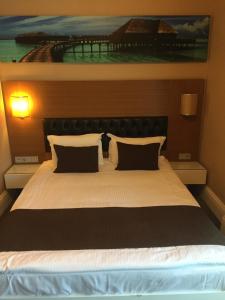 A bed or beds in a room at City Hotel Plovdiv