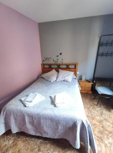 a bedroom with a bed with two towels on it at Hostal El Bodegon in Ateca