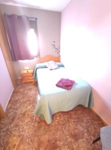 A bed or beds in a room at Hostal El Bodegon