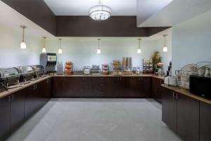 a large kitchen with wooden counter tops in a restaurant at Wingate by Wyndham Memphis East in Memphis