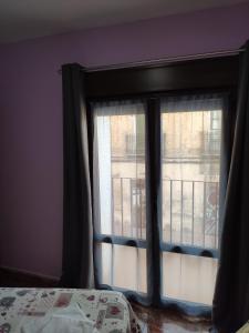 A bed or beds in a room at Hostal El Bodegon