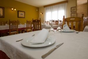 a table with white plates and napkins on it at Casa Puyuelo Tierrantona in Tierrantona +14 photos