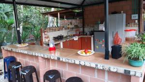 a kitchen with a counter with a bowl of fruit at Los Balcones Hostal - Caliyaco in Mocoa