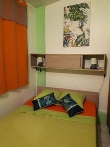 a bedroom with a bed with two pillows on it at Ô Fil de l'Eau in Pointe-Noire +51 photos