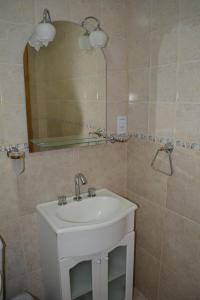 a bathroom with a white sink and a mirror at Monseñor Fagnano 592 "D" in Ushuaia +22 photos