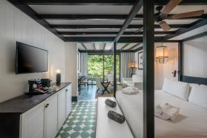 a bedroom with a bed and a living room at Ocean Riviera Paradise All Inclusive in Playa del Carmen