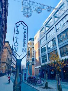 a sign for a restaurant on a city street at X Farringdon Apartments in London