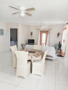 a dining room with a table and chairs at Clearwater Apartments in Christ Church