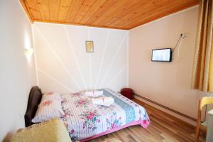 a bedroom with a bed in a room with a wooden ceiling at Apartments Jeca in Zlatibor