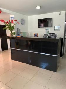 a black counter in a room with a clock on the wall at Hotel Casa Guillermo in Bogotá