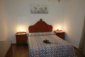a bedroom with a bed with two candles on two tables at Casa Luisita in Históric Center of Santa Lucía in Santa Lucía