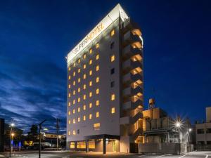 a hotel with a lit up building at night at Super Hotel Echizen Takefu in Echizen-shi