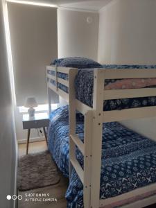 a couple of bunk beds in a room at Departamento Papudo in Papudo +19 photos