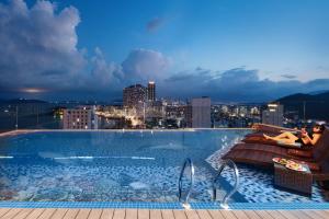 a swimming pool with a view of a city at Senia Hotel Nha Trang in Nha Trang