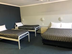 a hotel room with two beds in a room at Flinders Motel in Wollongong