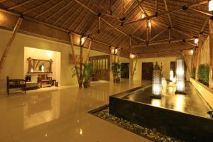 a large room with a fountain in the middle of a building at Living Asia Resort and Spa in Senggigi